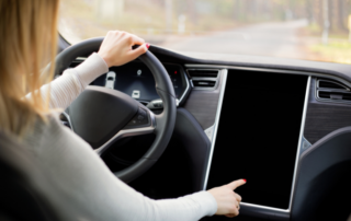 Woman driving Tesla car